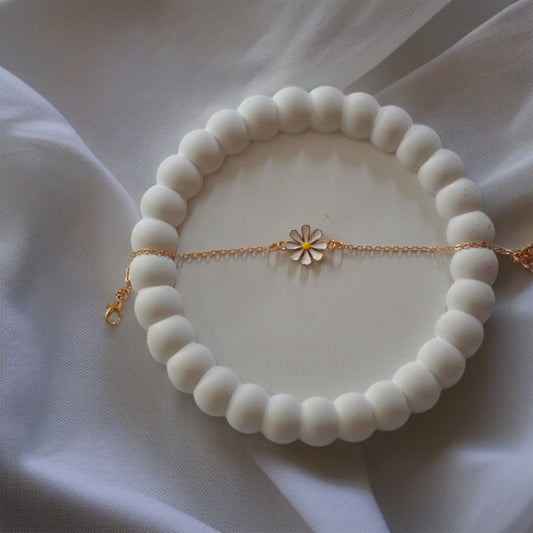 Gold-tone daisy chain bracelet with white enamel flowers